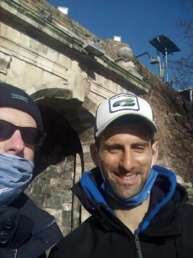 Novak Djokovic yesterday with a fan as he attended a church service in Belgrade