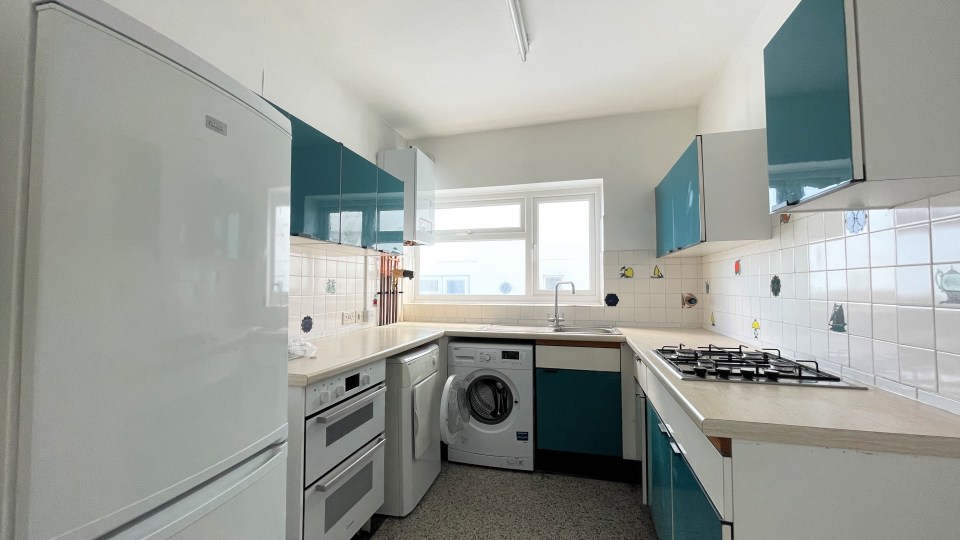 This modest two-bedroom flat has gone on the market for an eye-watering £1.5million despite needing a 'freshening up'