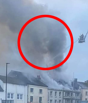 A creepy face seemed to appear in the smoke as a 'haunted' pub burned down