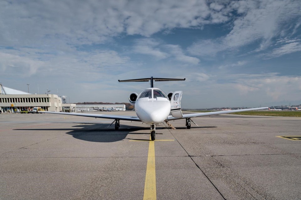 a small plane is parked on a runway with a yellow line