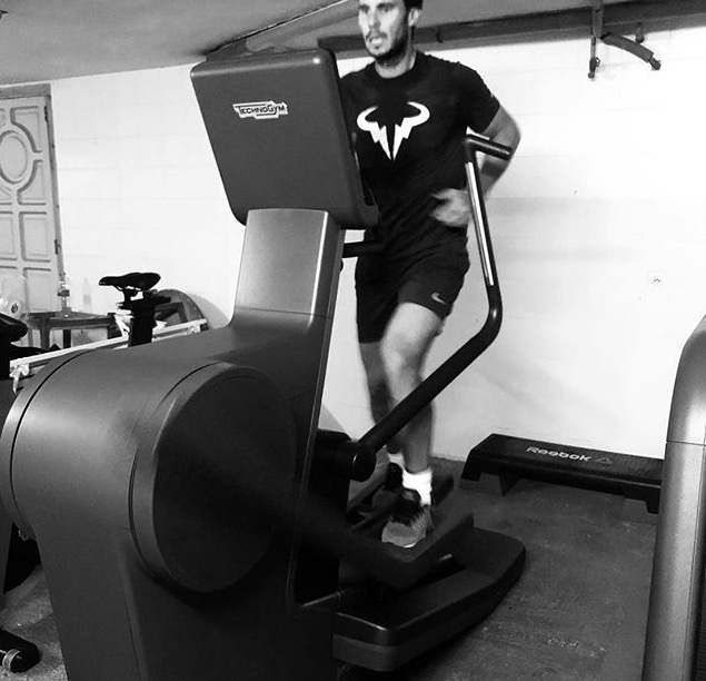 a man is running on a treadmill that says technogym