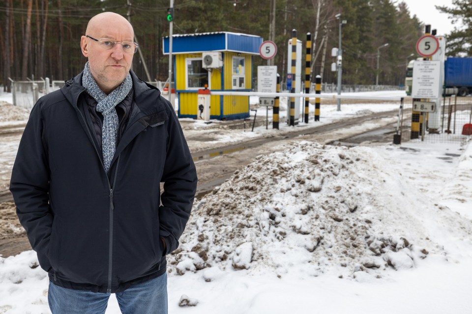 Nick Parker stands at the northern border crossing Ukraine shares with both Belarus and Russia