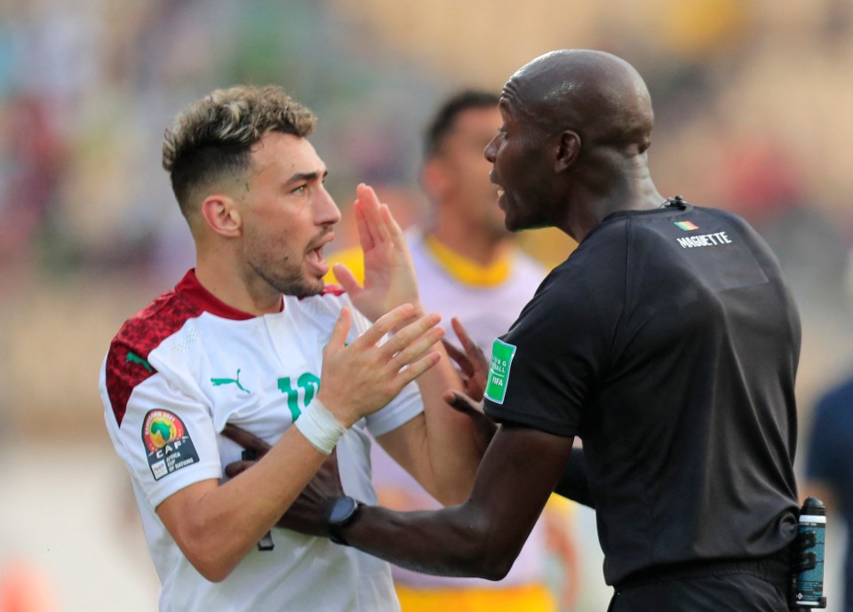 Munir El Haddadi complains to the referee moments before he is pushed to the floor