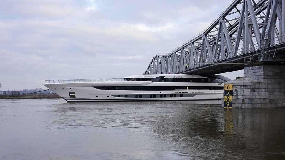 A multimillion-pound super-yacht scrapes under a rail bridge