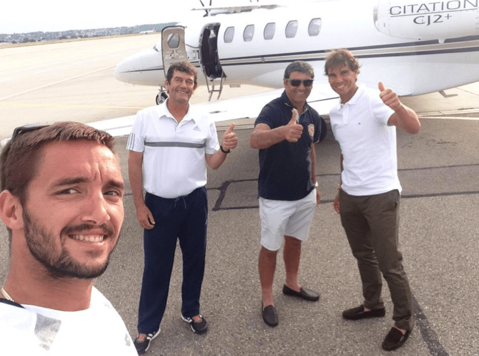 four men are standing in front of a citation cj2 + private jet