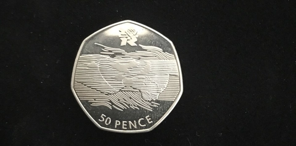 In the proper copy od the coin, there shouldn't be lines across the swimmers face