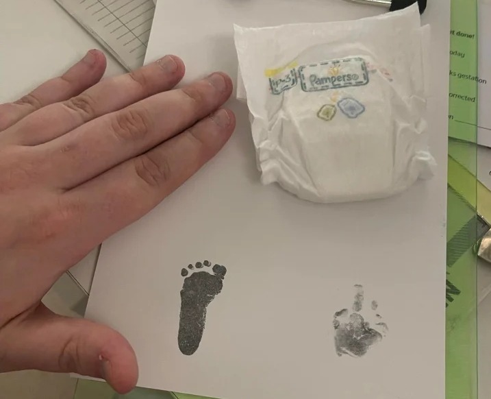 Hanna's footprint next to her mum's hand