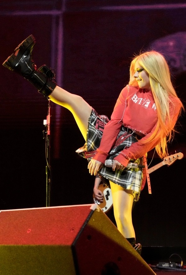 Avril Lavigne stunned in a plaid skirt and red crop top as she took the stage in California