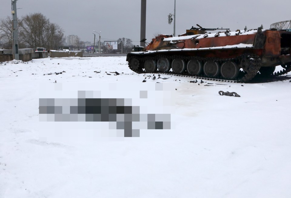 A body and a damaged tank are pictured on the outskirts of Kharkiv