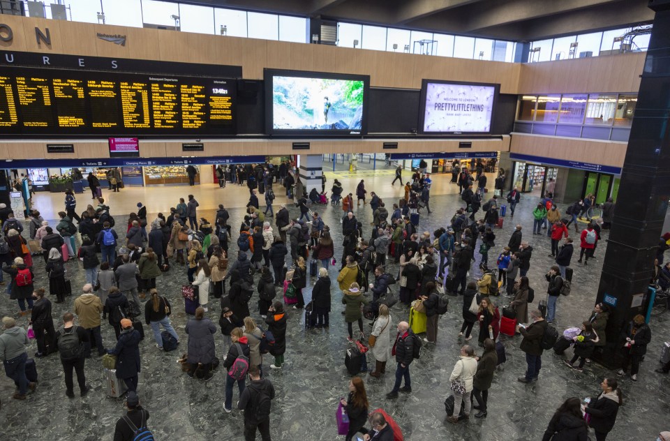 Crowds wait at a London train station amid widespread delays and cancellations