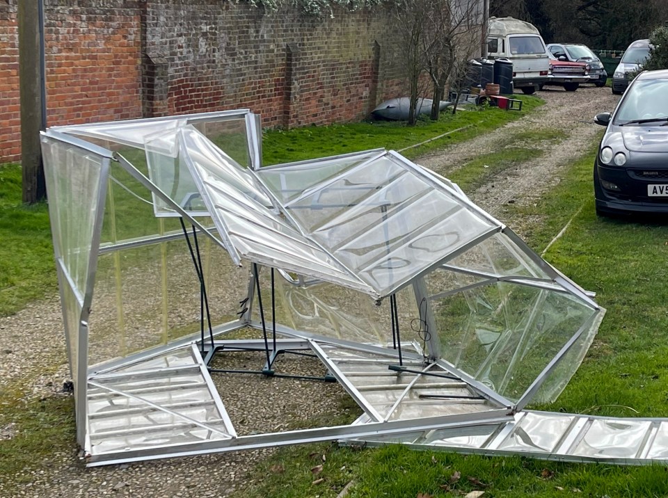 A greenhouse after being blown about in a garden at Hatfield Peverel in Essex