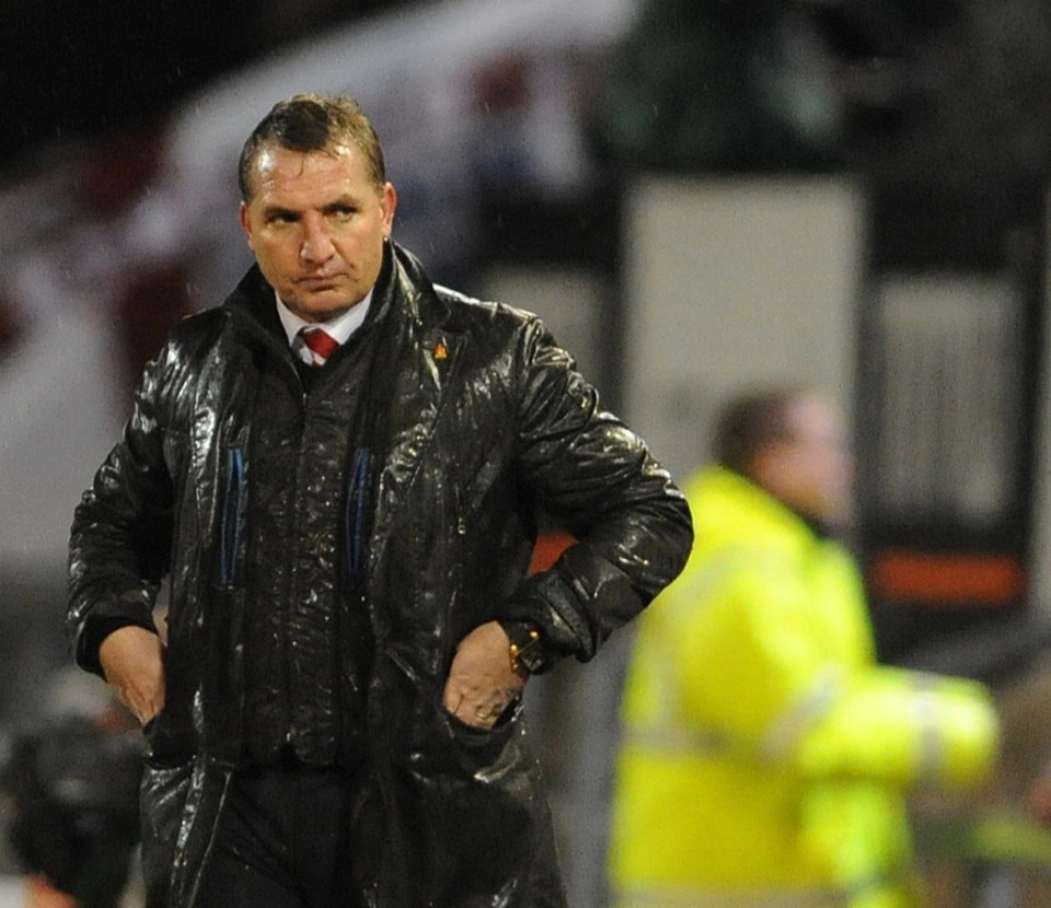 A soaked Brendan Rodgers looks on after his side were humbled by Oldham