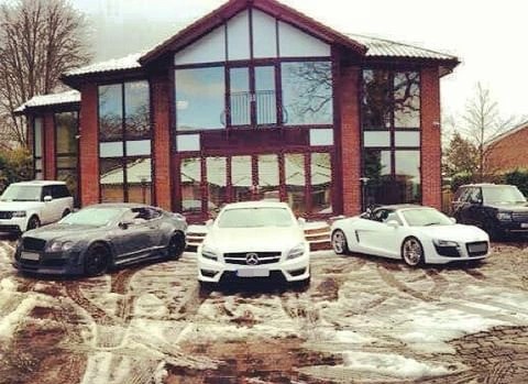 35-year-old Khan’s car collection sits outside his former Bolton home