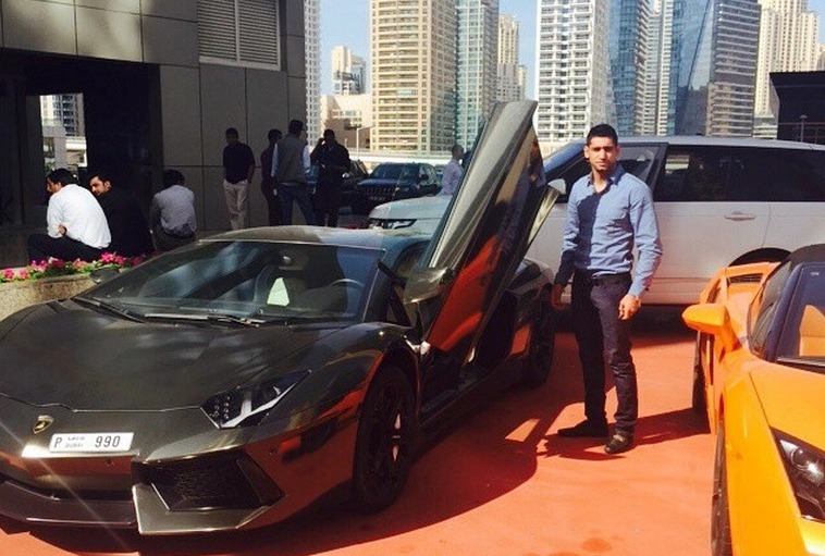 Khan poses with his £271,000 Lamborghini Aventador