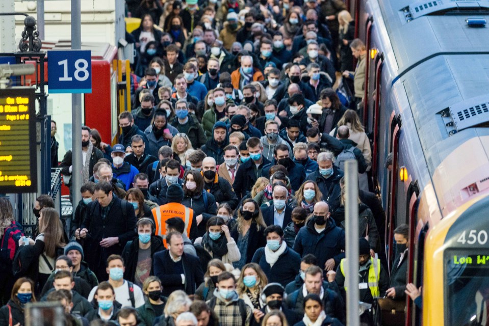 Masked commuters during morning rush hour at Waterloo station in London