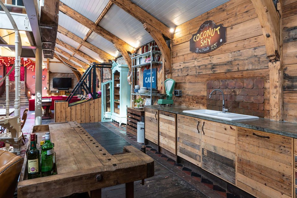 A cocnut shy sign hangs above the kitchen sink