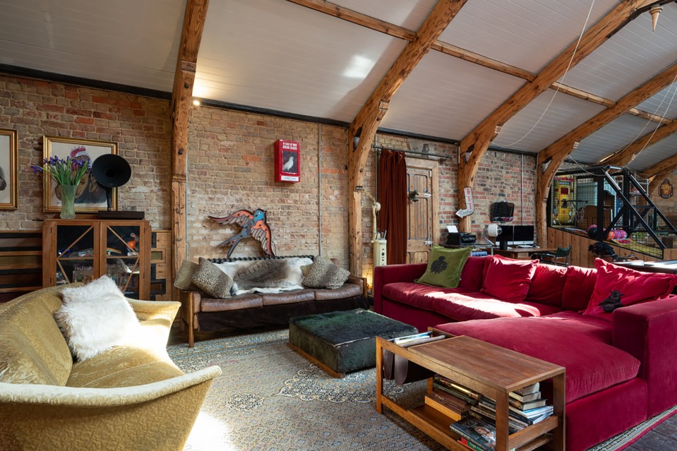 Exposed beams and bricks run through the living area