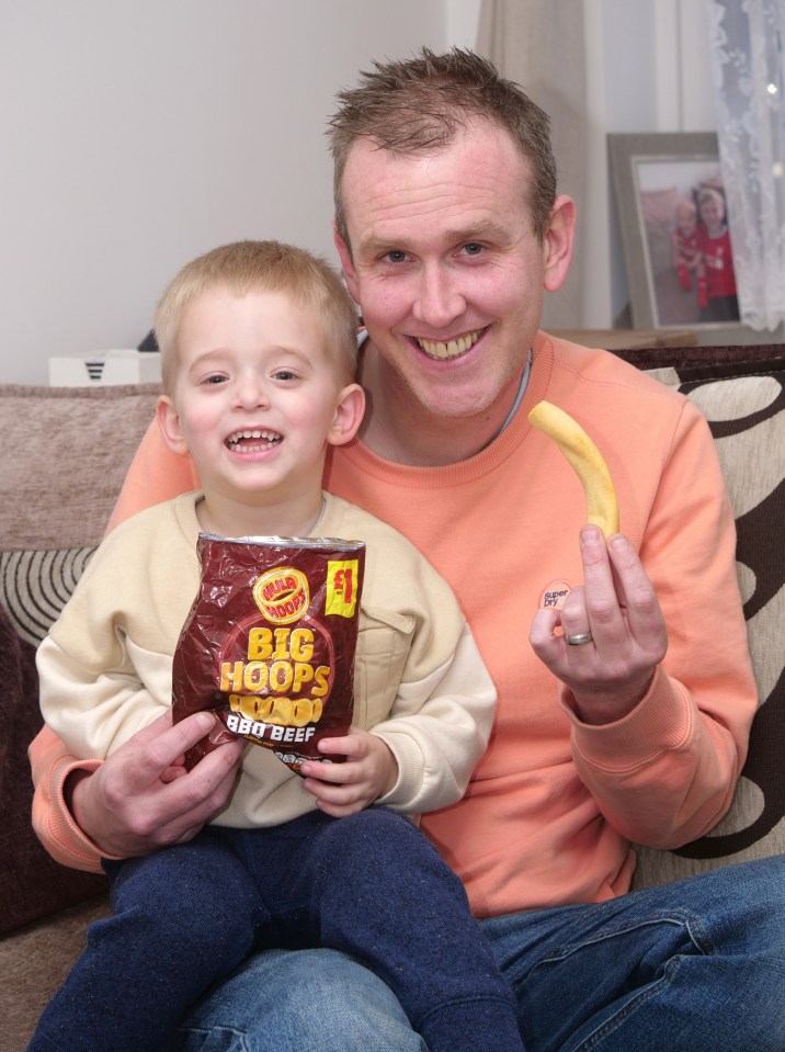 The toddler pulled the colossal crunchy out of the BBQ Beef flavour bag he was munching through