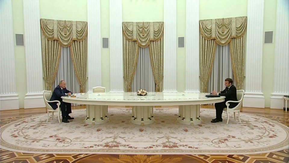 Vladimir Putin held talks with Emmanuel Macron from a distance — as the pair sit at different ends of a huge table to discuss security