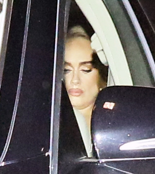 Adele was busy concentrating on her phone as she was whisked away from Soho House