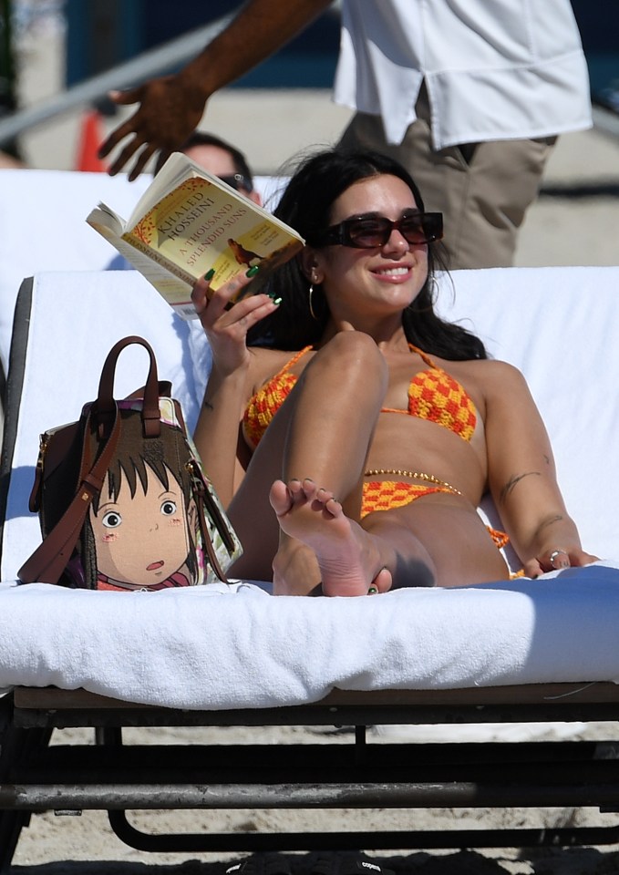 Dua also  got her head stuck in a book while chilling in the yellow and orange bikini