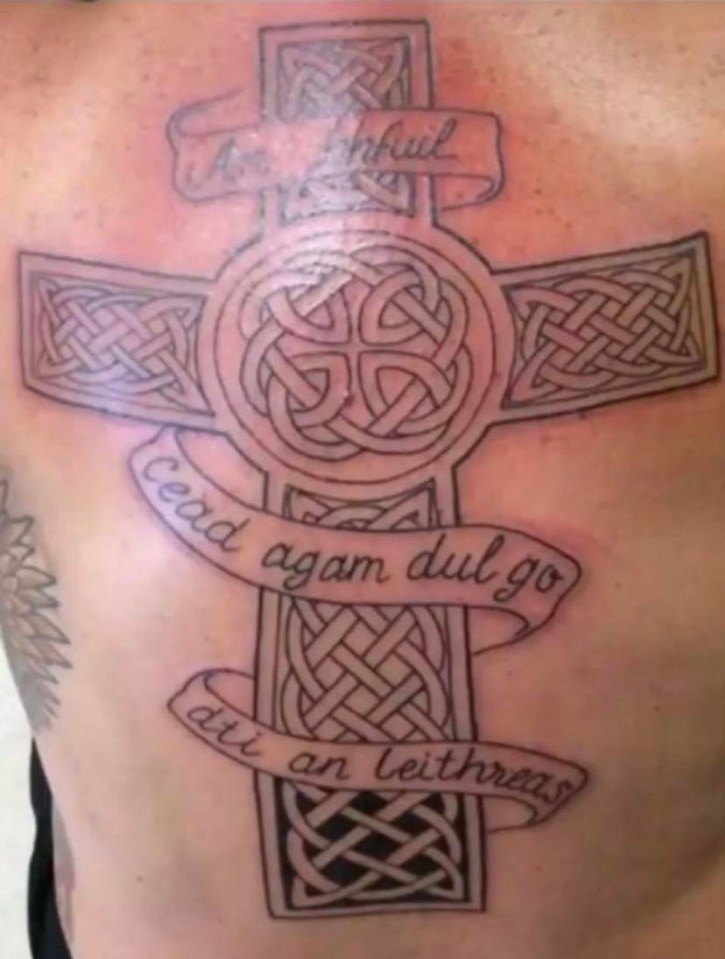 The tat features a Celtic cross with a few words in Gaelic