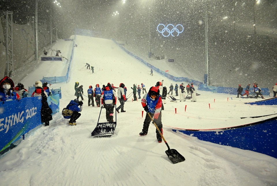 Genting Snow Park in Zhangjiakou was flooded with helpers tackling the snow caused by a surprise blizzard