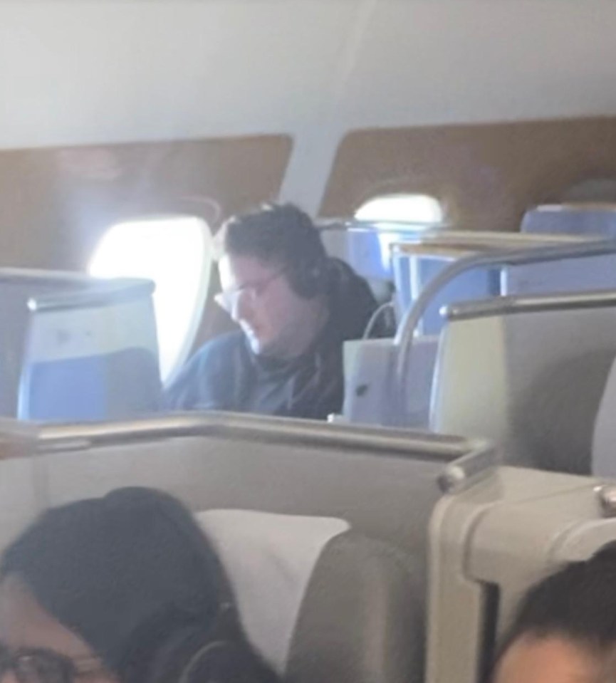 Dr Alex George seen without a mask onboard an Emirates flight