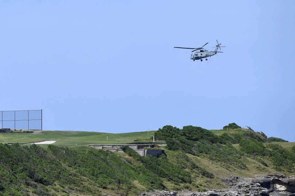 A navy helicopter hovers above the fatal shark attack site on little Bay in Sydney