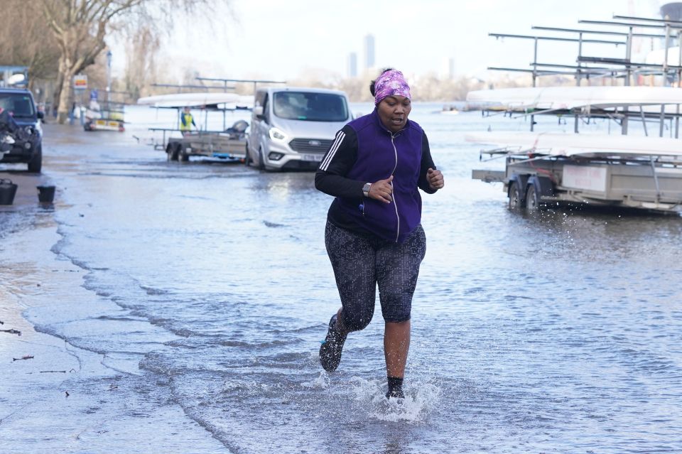 A brave runner in Putney, London battles the flooding