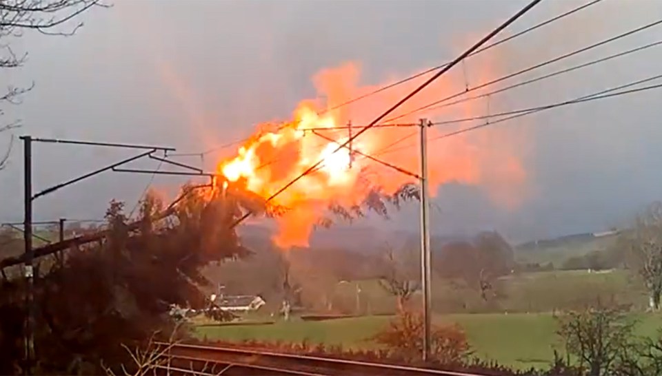 Flames after a tree collapsed on overhead lines on a Scots railway