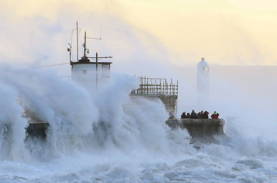 Waves crash against the harbour wall during storm Eunice in Porthcawl, Wales