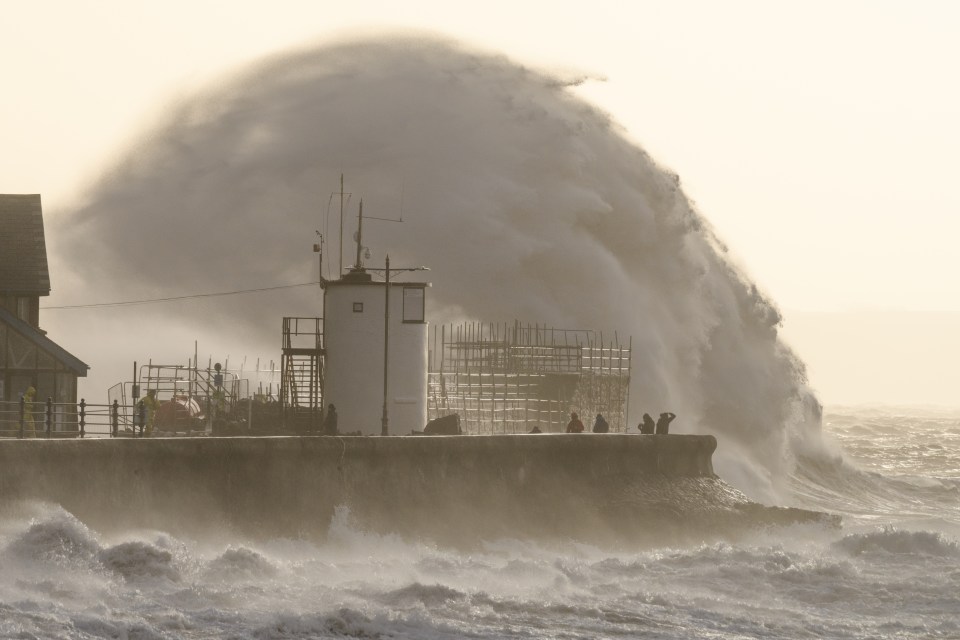 Large waves crash over the sea defences in Porthcawl, South Wales