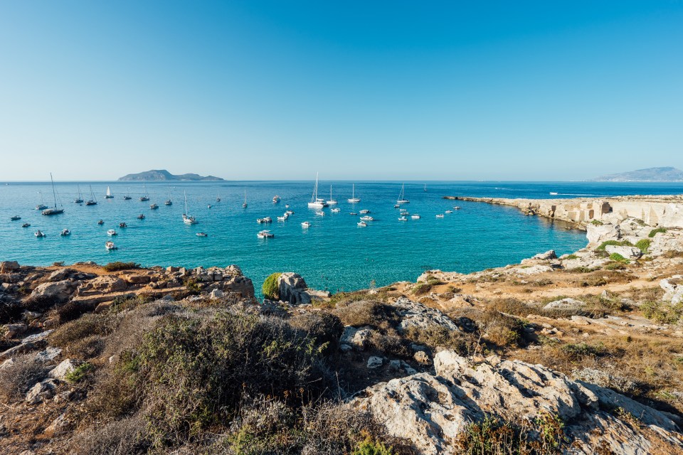 Spiaggia di Cala Rossa is a small but perfectly formed beach that sits alongside seas of astonishing blue intensity