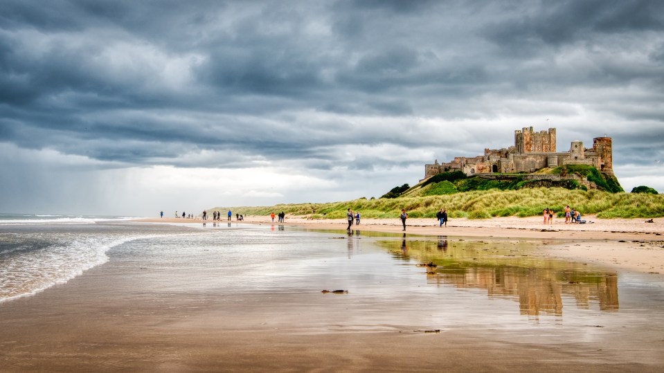 Bamburgh Castle towers over this wide expanse of pristine sands backed by dunes