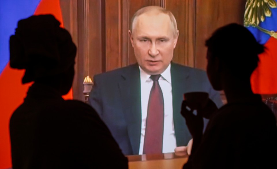 Russians watch Putin making an address to the nation