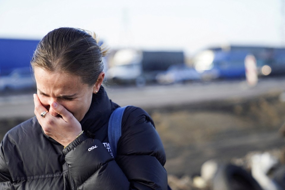 A woman cries after crossing the border into Poland from Ukraine