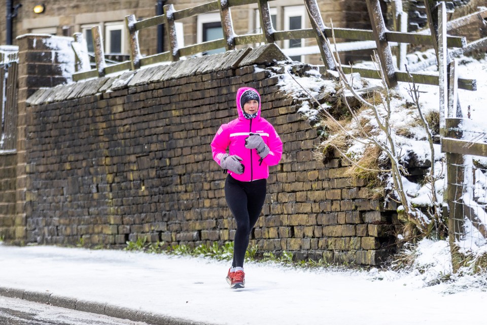 A jogger seen making their way through frost and flakes in Queensbury, Yorks