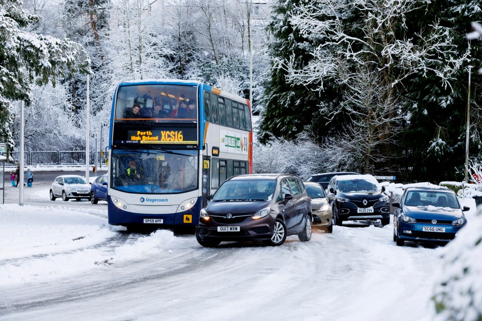 Cars and a bus stuck battle along a road in Perthshire after heavy overnight snow