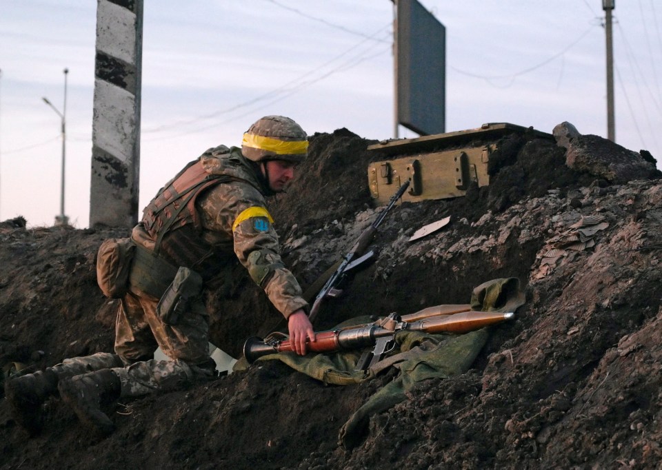 A Ukrainian soldier holds a rocket-propelled grenade launcher outside the city of Kharkiv