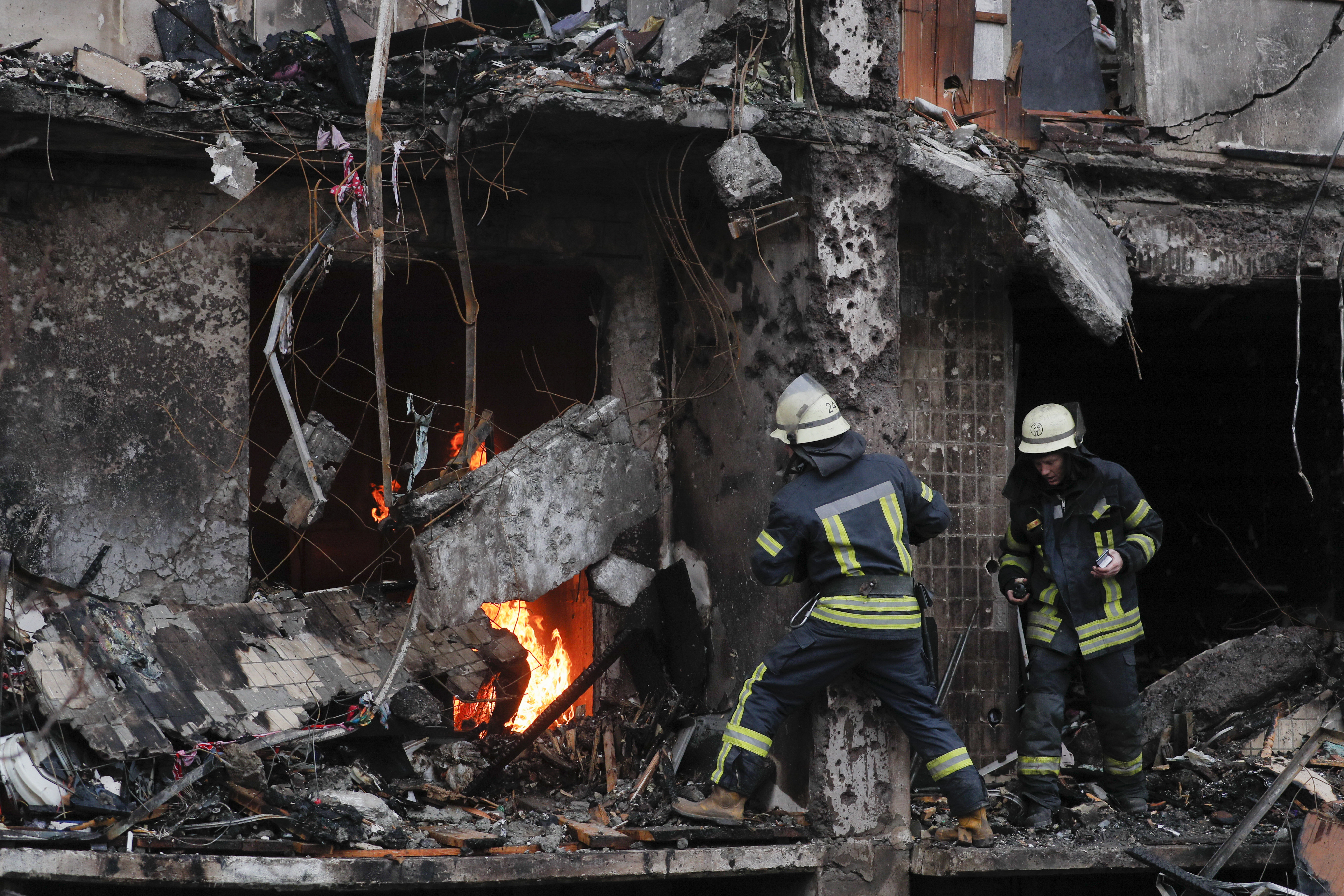 Firefighters deal with the aftermath of Russian shelling in Kyiv