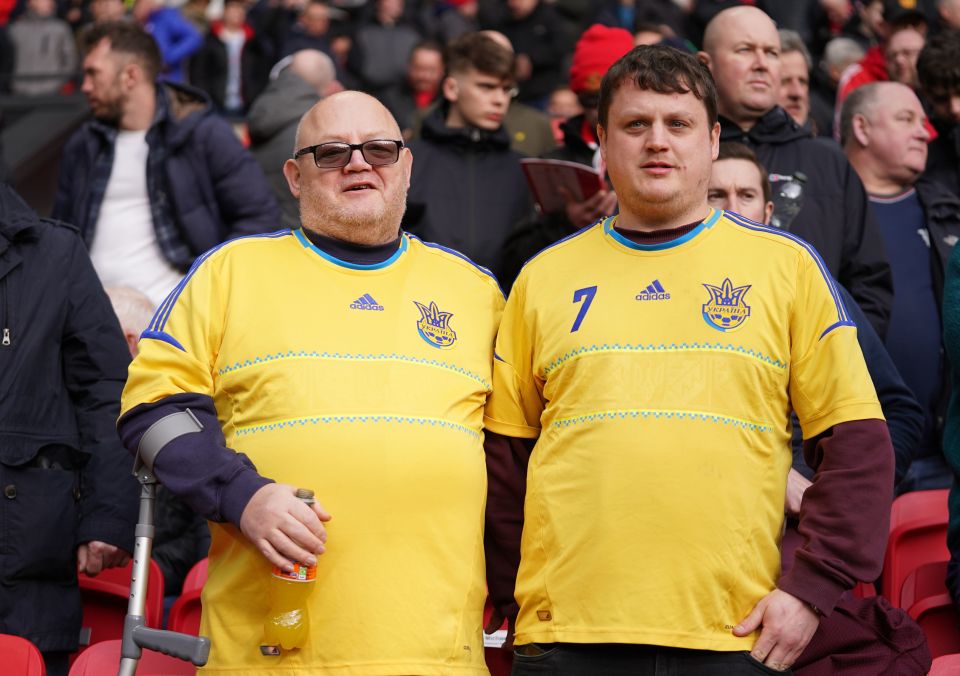 Two fans wear Ukraine national football team shirts in support of the country