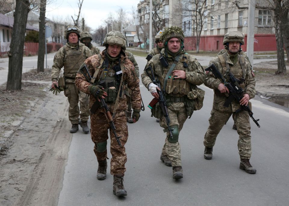 Brits are rushing to sign up to join Ukrainian troops, pictured, in their fight against Putin's invasion