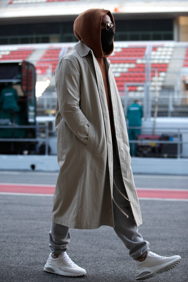 Hooded Hamilton strolled down the pit-line peering into garages looking at his rivals' cars