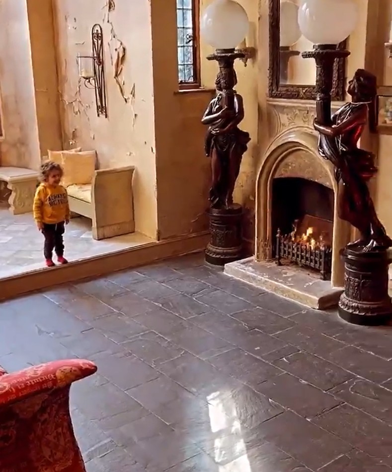 She showed off the impressive living area with a fireplace and statues