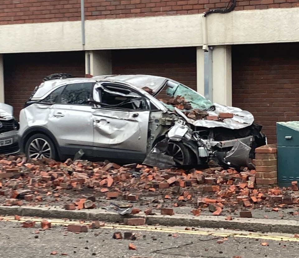 Bricks falling from a tower block destroyed a car during the high winds