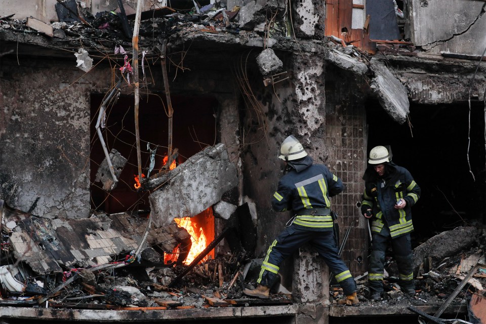 Firefighters tackle a blaze after a building was hit by Russian fire power