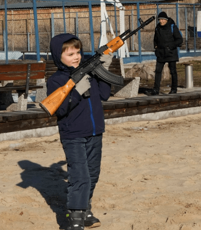 Another child was pictured joining in the military training excercise for civilians