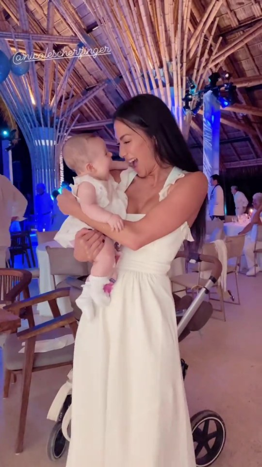 She looked besotted with her baby niece during a friend's wedding