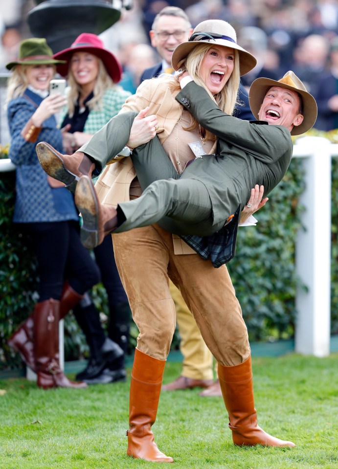 Penny was snapped with jockey Frankie Dettori in her arms